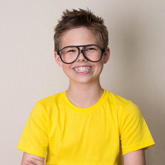 Teen boy with orthodontic appliance smiling