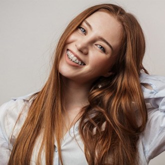 a closeup of a patient with braces smiling 