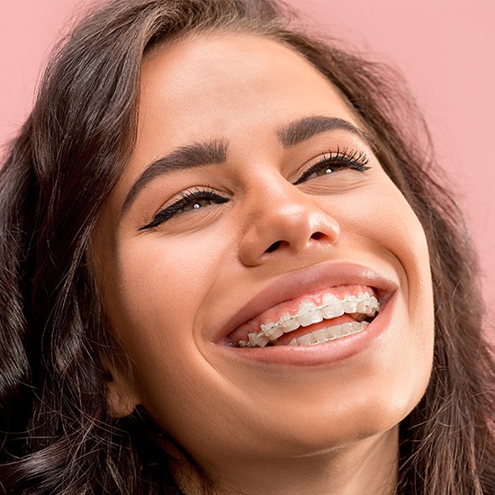 Woman with clear and ceramic braces smiling