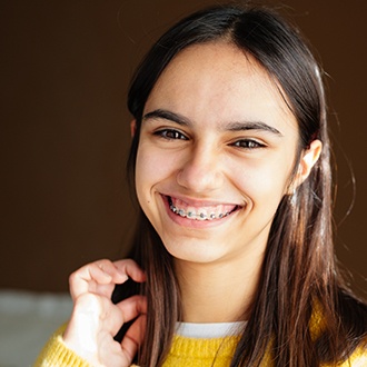 a patient with braces smiling