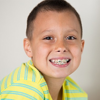 Smiling young boy with pediatric orthodontics