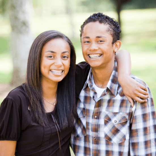 Two smiling teen with braces