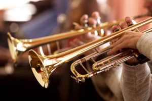 Closeup of person with braces in Milton playing the trumpet