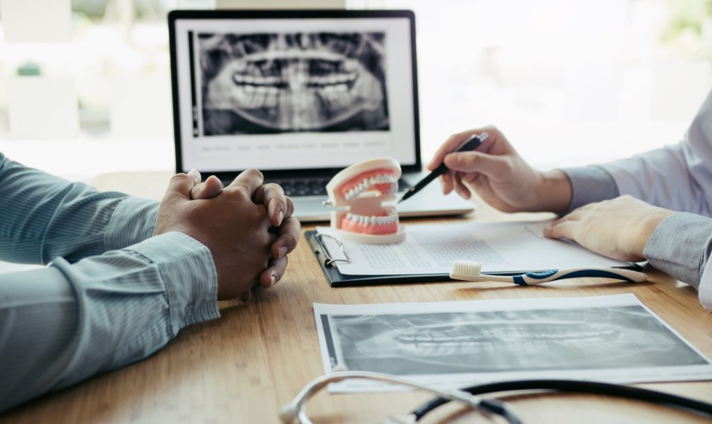 Orthodontist explaining overbite to patient in office