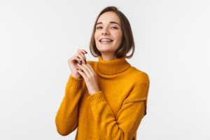 an adult with braces smiling confidently