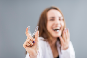 a patient holding their Invisalign tray
